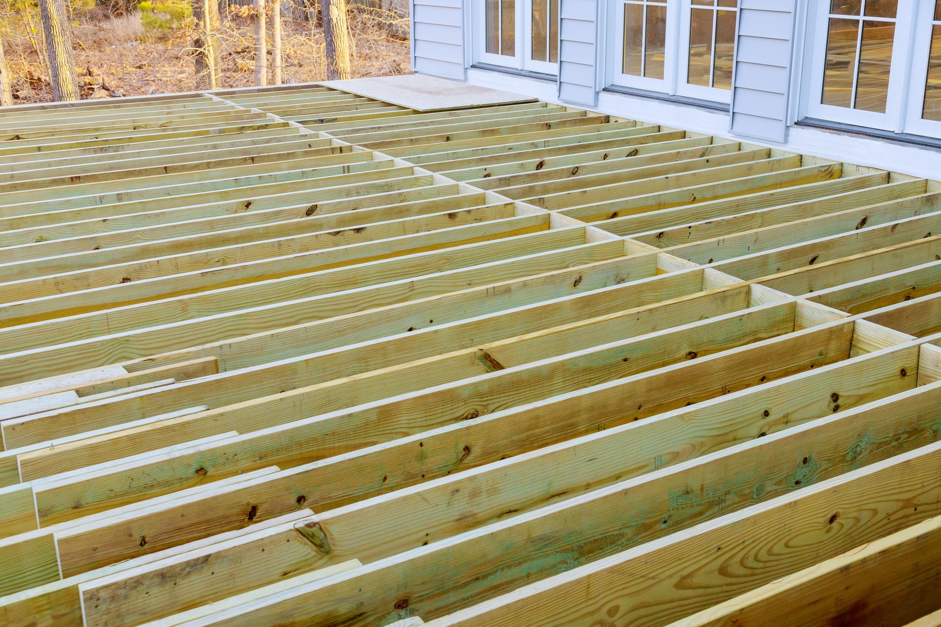 Fragment planks installing wood floor for patio deck with new wooden planks